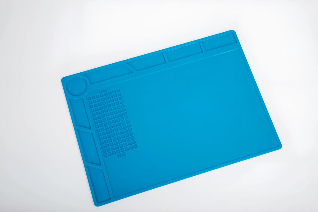 Blue silicone anti-skid pad for watch repair on a workbench, showing non-slip surface