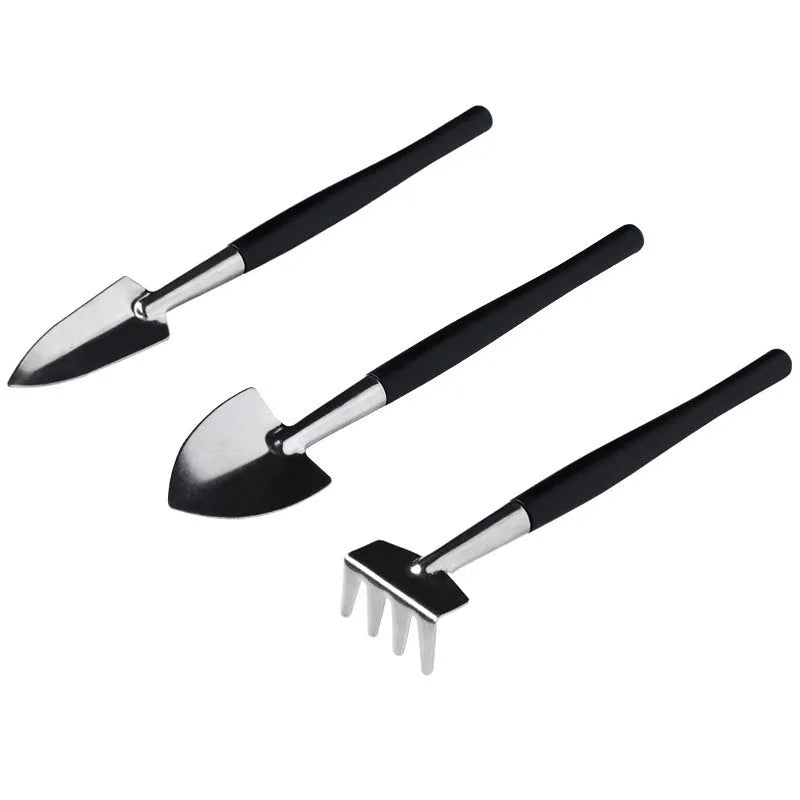 Black mini succulent garden tool set showing scissors, tweezers, shovels, rake, watering bottles, and a cushion for small plant care.