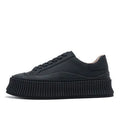 Women's black suede platform lace-up trainers with chunky rubber sole and cross-binding detail on the upper.