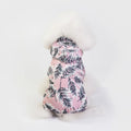 Waterproof dog raincoat in pink, four-legged jumpsuit style, on a small dog