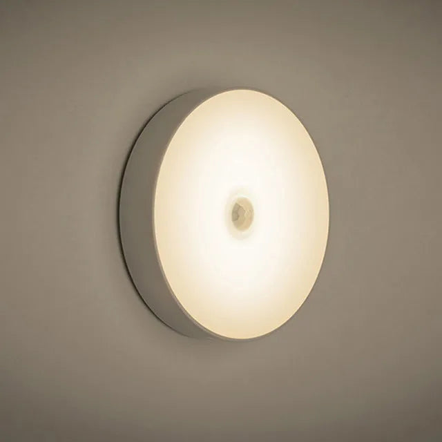White circular motion sensor LED night light with USB charging cable and adhesive tape