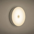 White circular motion sensor LED night light with USB charging cable and adhesive tape