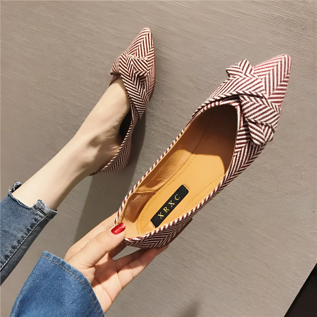 Women's pointed toe single shoes in black or red with shallow mouth design and low flat heel