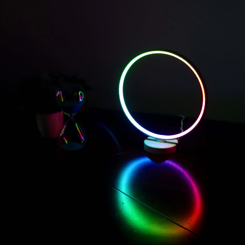 White Full Moon Mood Lamp table light with remote control on a surface.