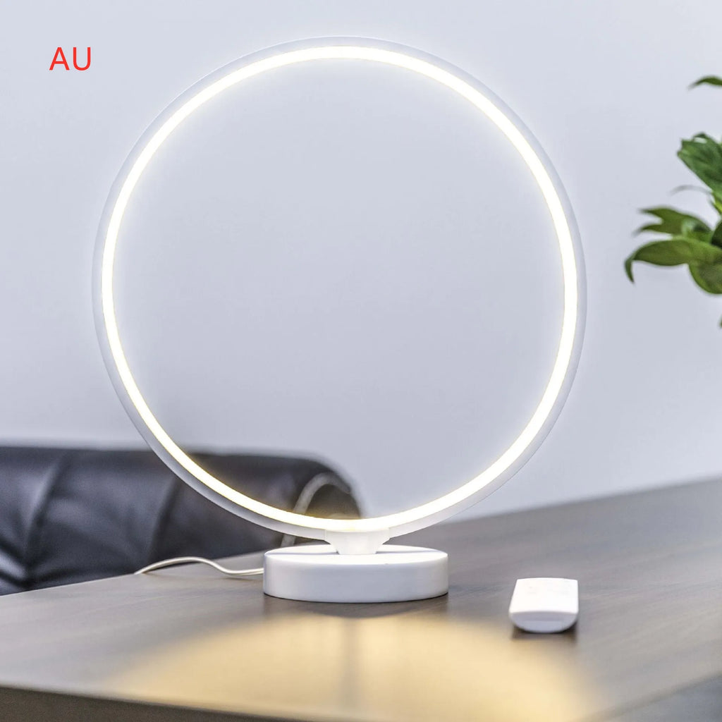 White Full Moon Mood Lamp table light with remote control on a surface.