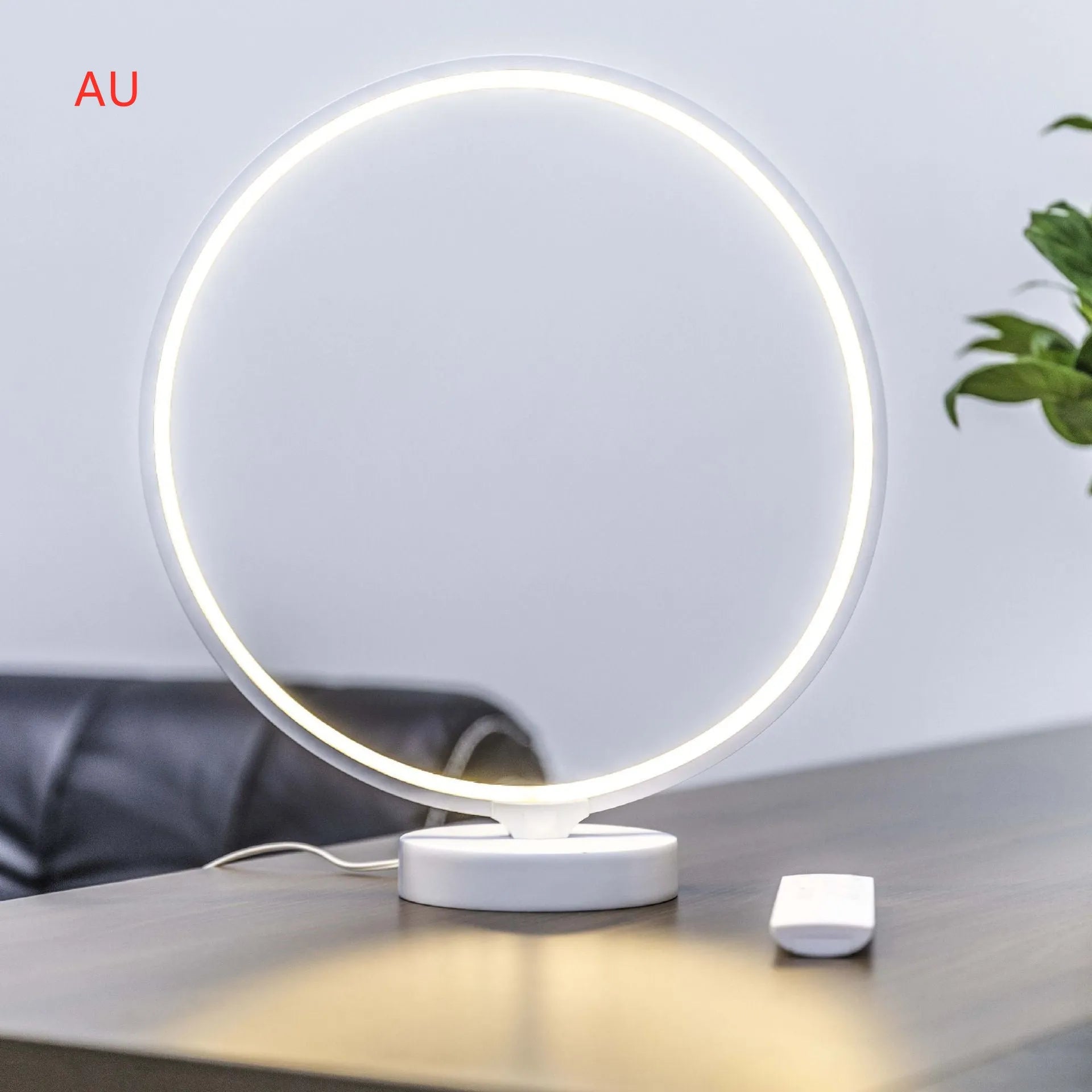 White Full Moon Mood Lamp table light with remote control on a surface.
