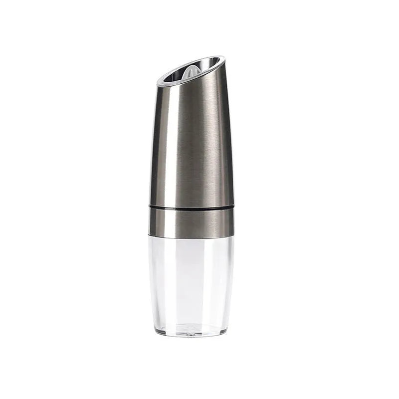 Electric gravity pepper grinder with clear acrylic body and blue LED light on a kitchen countertop