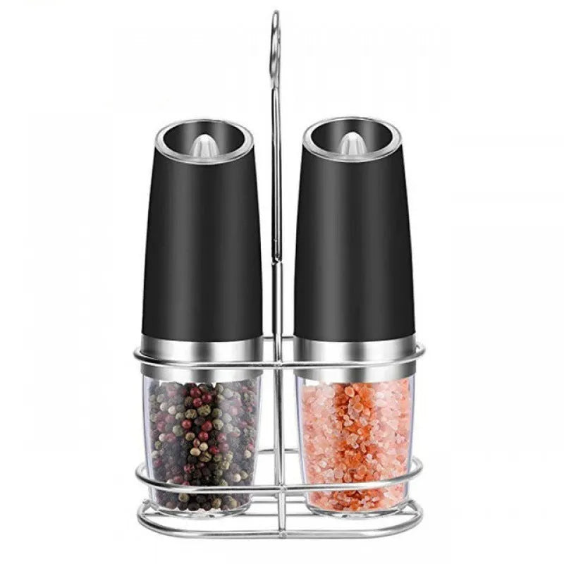 Electric gravity pepper grinder with clear acrylic body and blue LED light on a kitchen countertop