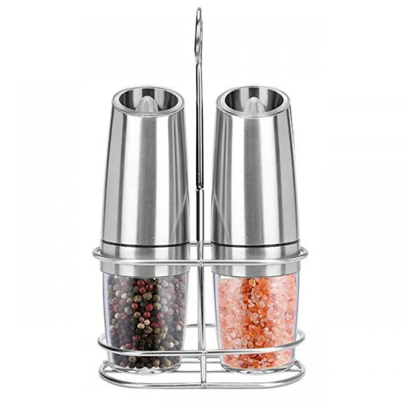 Electric gravity pepper grinder with clear acrylic body and blue LED light on a kitchen countertop