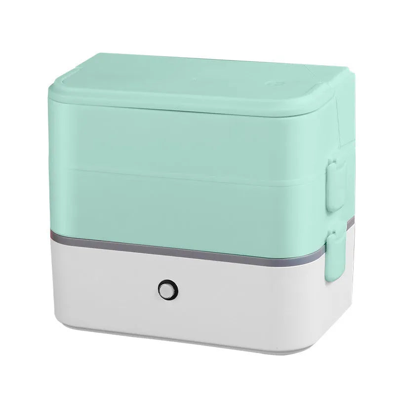 Pink and white portable heated lunch box with plug and push-button control.