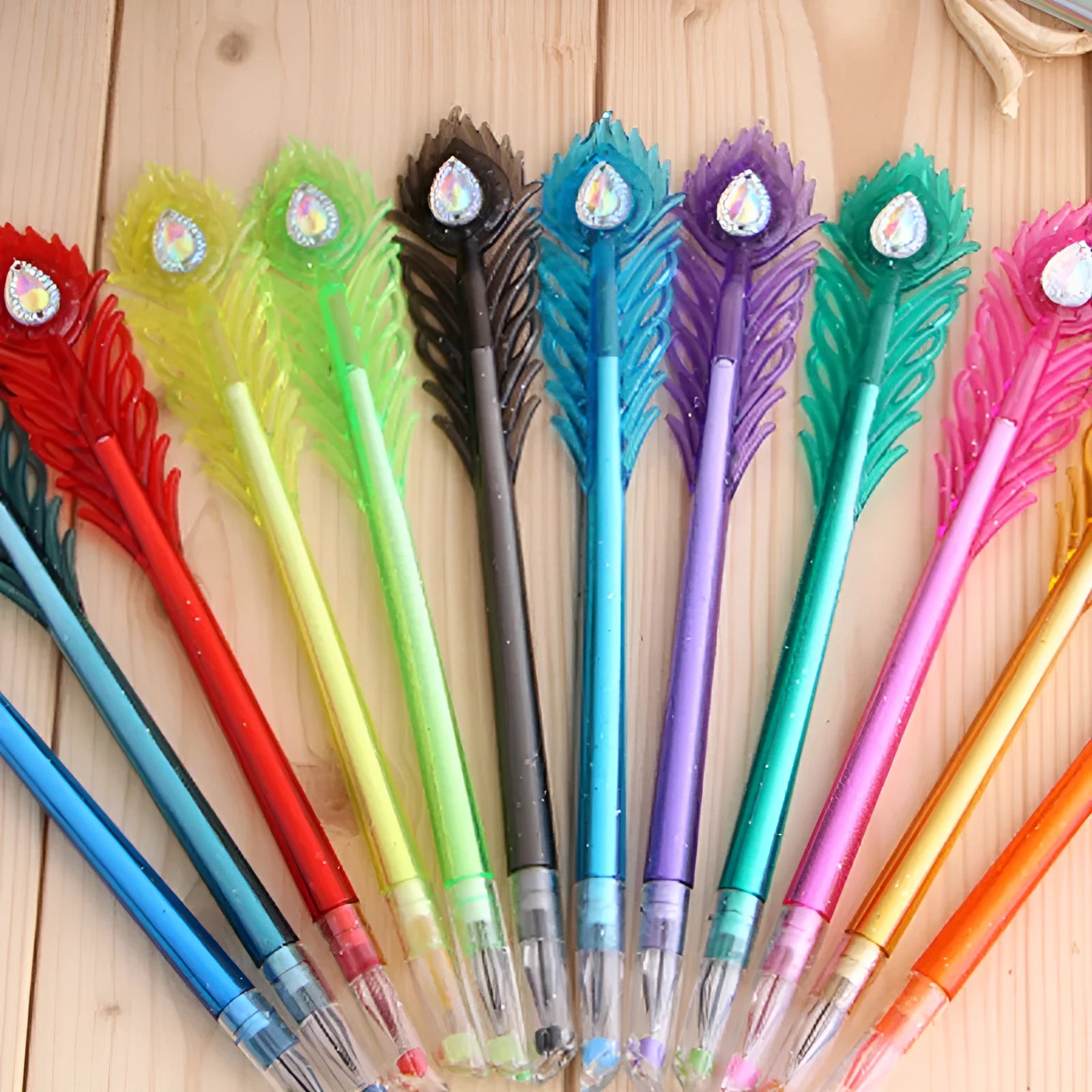 Twelve peacock feather design gel pens in assorted colours with fine 0.5mm tips and replaceable refills