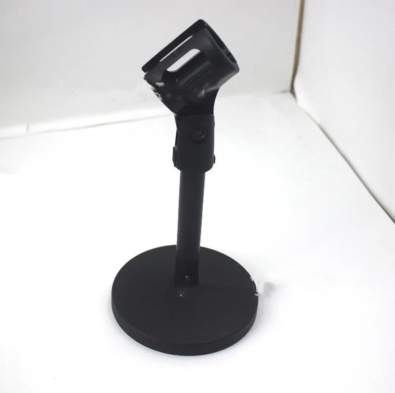 Black metal desktop microphone bracket with a circular base and plastic clip.