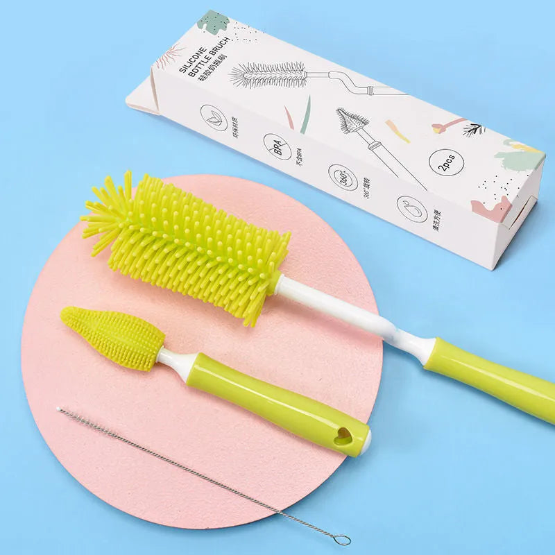 Silicone baby bottle cleaning brush and separate straw cleaner in pink, blue, and yellow colours.