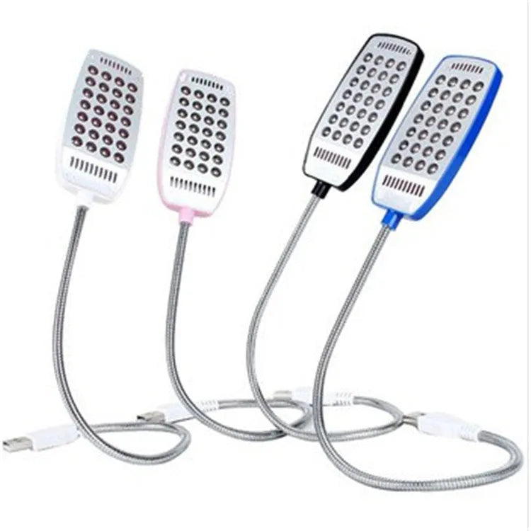 Black flexible USB gooseneck LED lamp bent over a laptop keyboard.