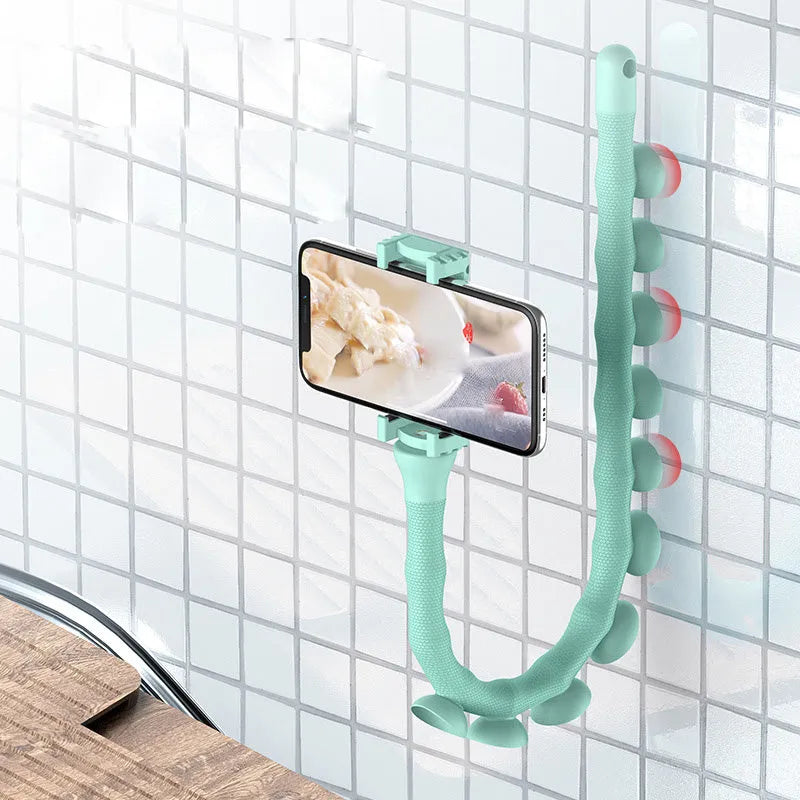 Flexible black rubber phone holder with suction cup wrapped around a bicycle handlebar, showing a phone mounted at an angle.