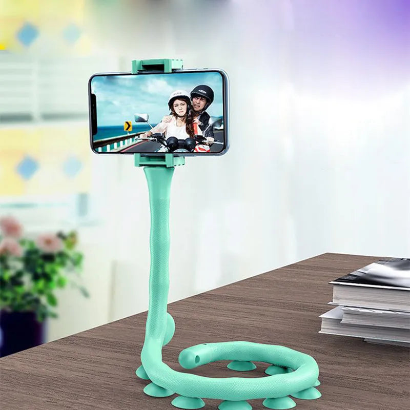 Flexible black rubber phone holder with suction cup wrapped around a bicycle handlebar, showing a phone mounted at an angle.