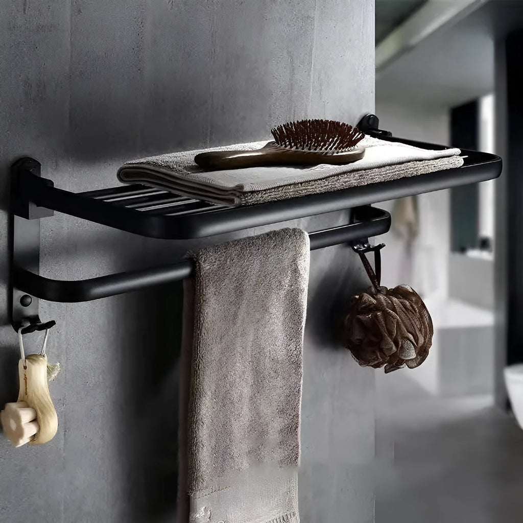 Silver aluminium double-decker folding bathroom shelf with towels, mounted on a wall.