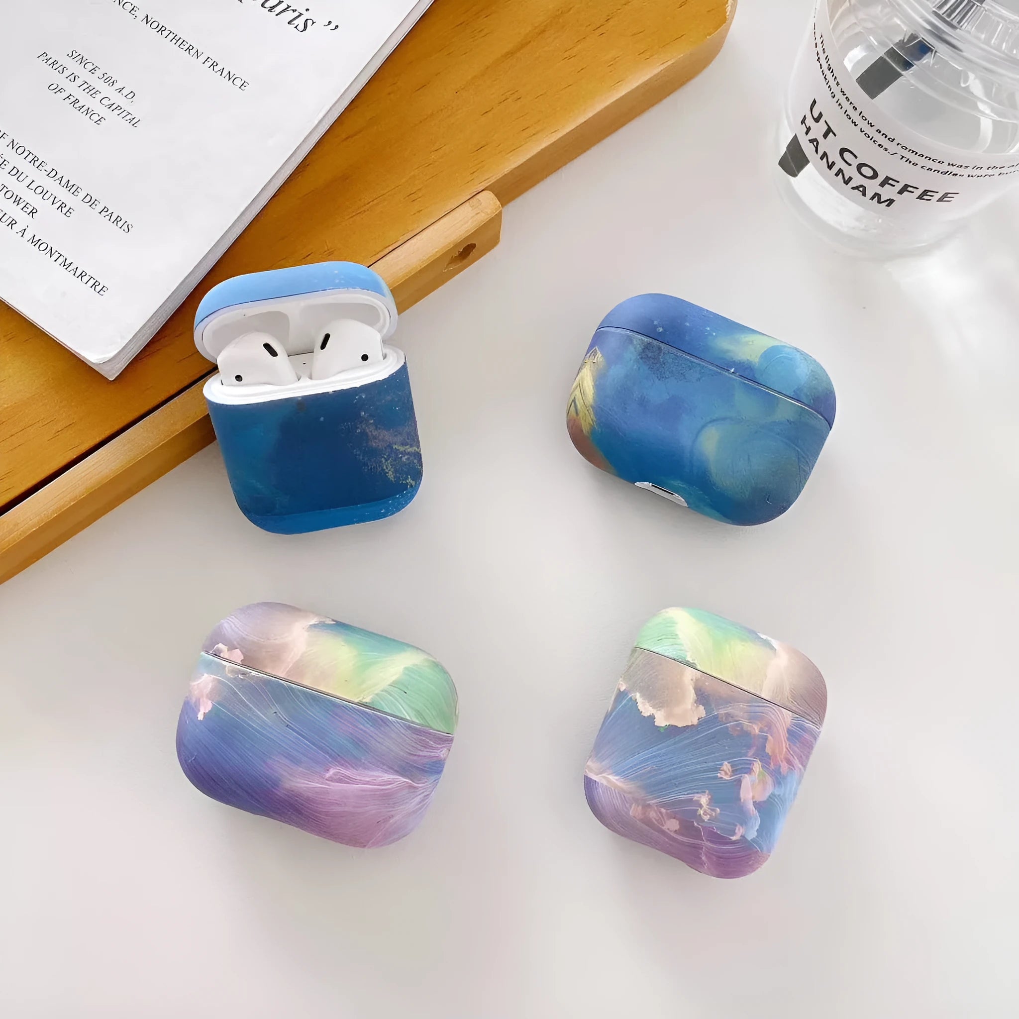 Hard shell protective case for Apple AirPods with watercolour design in pink or blue colours