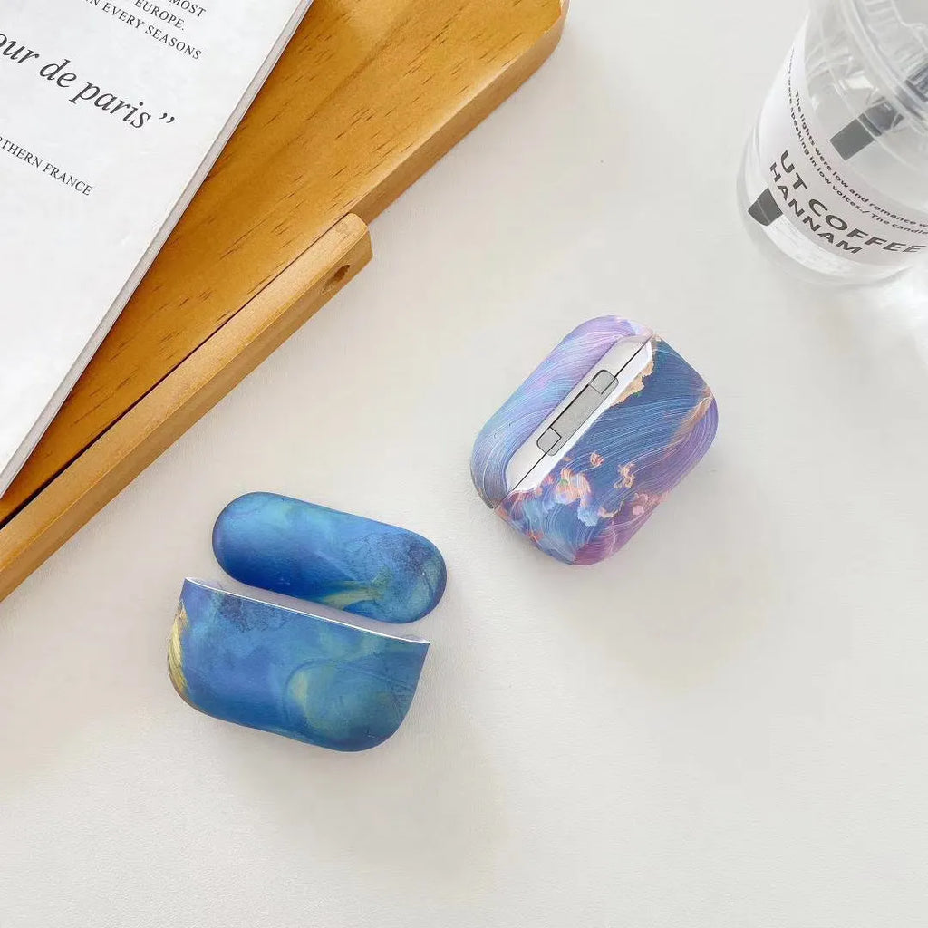 Hard shell protective case for Apple AirPods with watercolour design in pink or blue colours