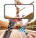 Black aluminium self timer tripod with extended legs and iPhone mounted in adjustable clamp