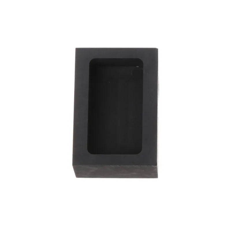 Square high-purity graphite crucible for melting gold, silver, and platinum on a work surface.