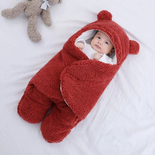 Baby quilted sleeping bag wrapper in cotton blend fabric, shown in grey colour with size tag.