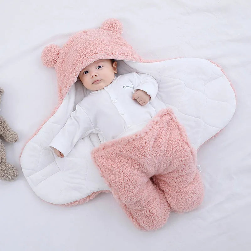 Baby quilted sleeping bag wrapper in cotton blend fabric, shown in grey colour with size tag.