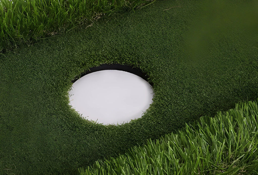 Green rectangular golf training mat with PP grass surface and cushioned EVA base, shown with a golf club.