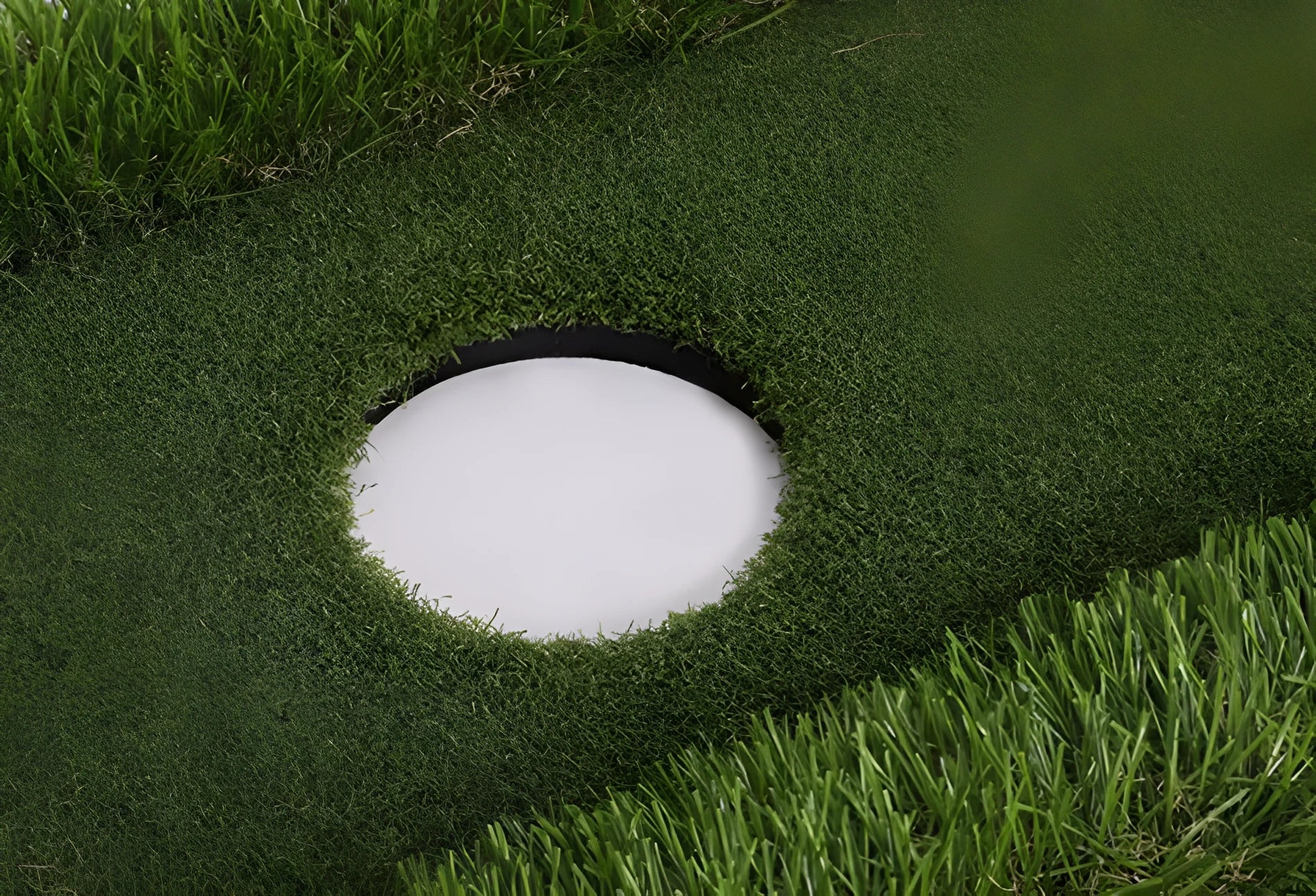 Green rectangular golf training mat with PP grass surface and cushioned EVA base, shown with a golf club.