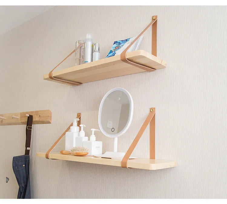Natural pine wood wall-mounted shelf in Nordic style for organising remotes, books, and cosmetics.