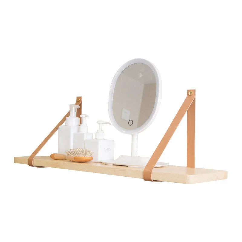 Natural pine wood wall-mounted shelf in Nordic style for organising remotes, books, and cosmetics.