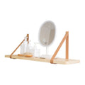 Natural pine wood wall-mounted shelf in Nordic style for organising remotes, books, and cosmetics.