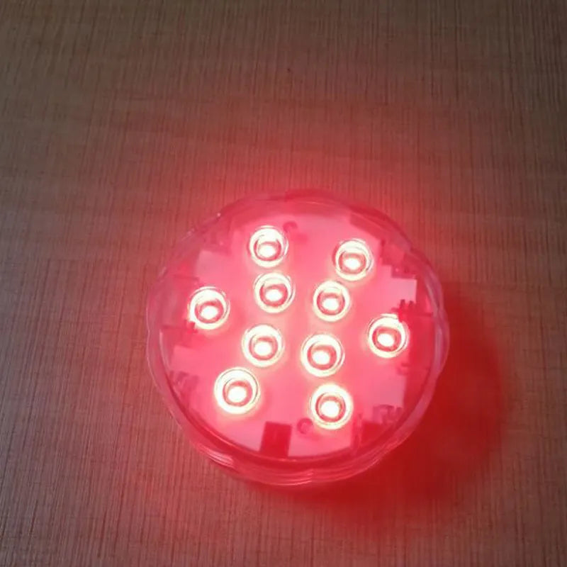 White circular IP68 waterproof RGB LED light with remote control for pools and gardens.