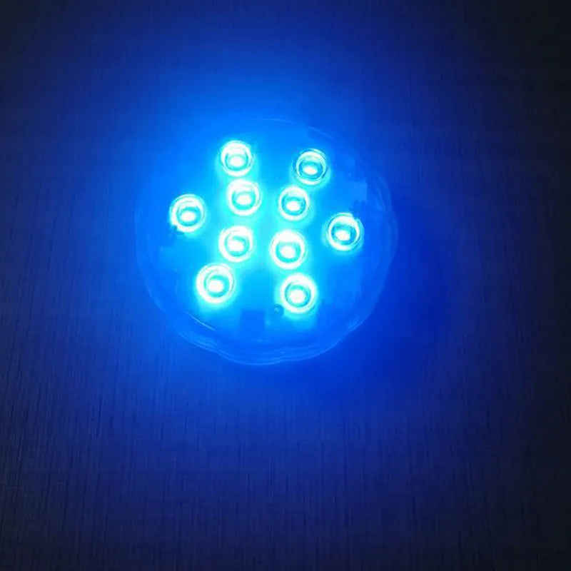 White circular IP68 waterproof RGB LED light with remote control for pools and gardens.