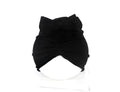 Soft acrylic knitted baby girl turban hat in a solid colour, shown on an infant.