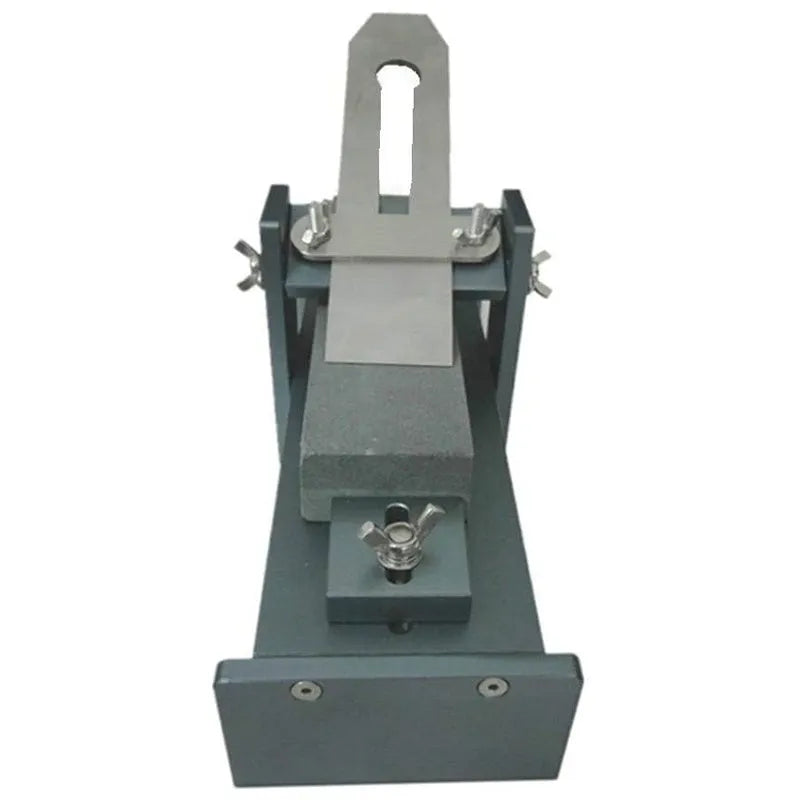 Aluminium and stainless steel fixed angle sharpening tool for chisels and planers on a workbench.