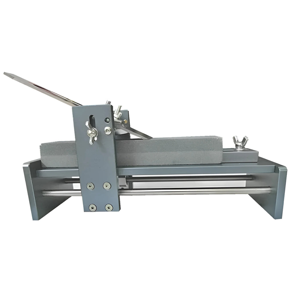 Aluminium and stainless steel fixed angle sharpening tool for chisels and planers on a workbench.