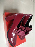 Black patent leather women's high-heel shoes with a thick heel and square toe.