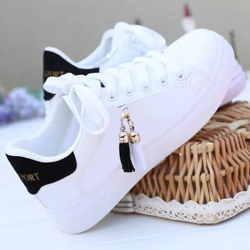 White women's mesh fashion trainers with lace-up front and flat rubber sole.