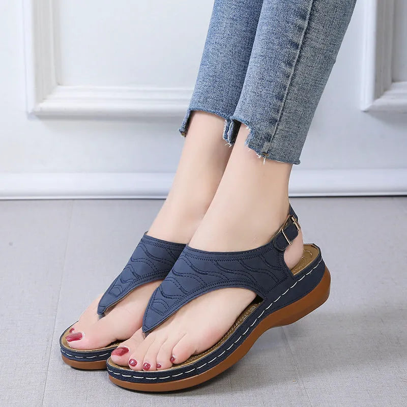 Women's casual wedge heel flip flop sandals with adjustable back strap in red vegan leather