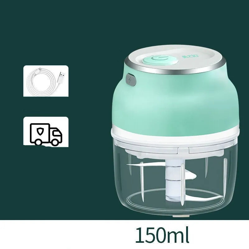 Portable electric mini garlic cutter with transparent cup and stainless steel blade on kitchen counter