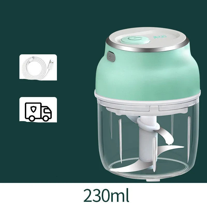 Portable electric mini garlic cutter with transparent cup and stainless steel blade on kitchen counter