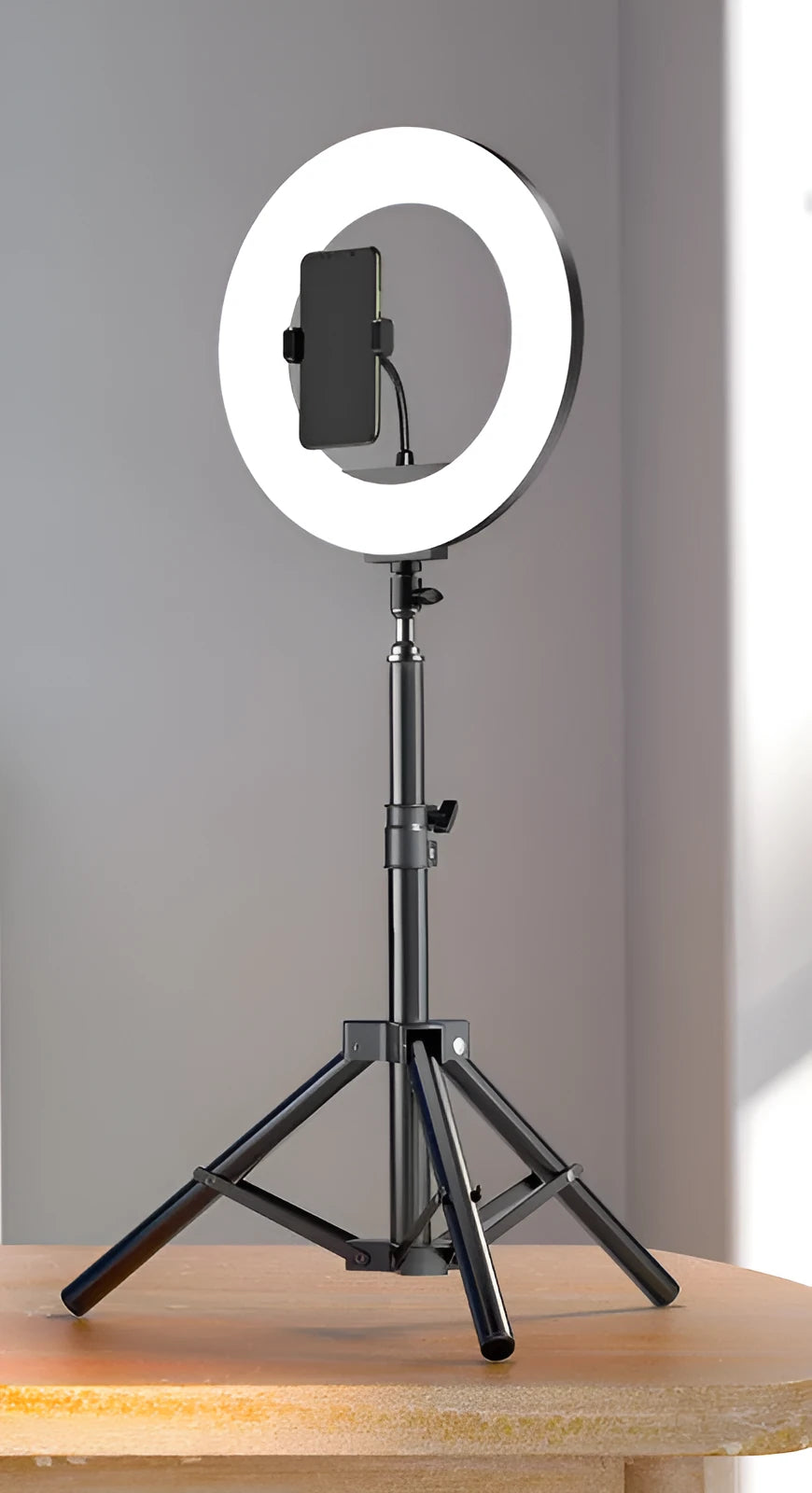 Carbon steel mobile phone tripod with a 10-inch ring light attached, shown next to its storage bag.