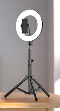 Carbon steel mobile phone tripod with a 10-inch ring light attached, shown next to its storage bag.