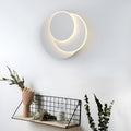 Modern round acrylic wall lamp in black or white, shown in large, medium and small sizes.