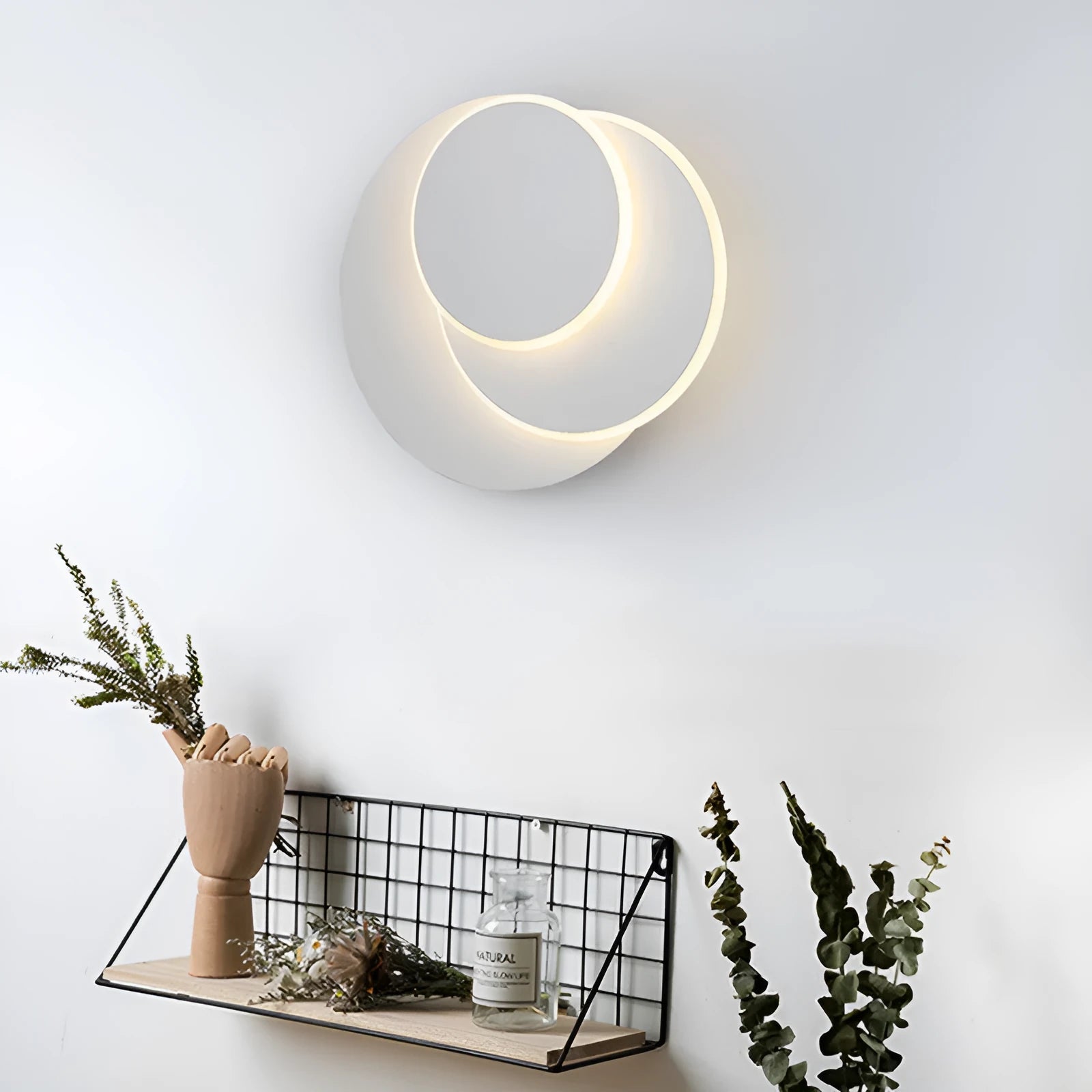 Modern round acrylic wall lamp in black or white, shown in large, medium and small sizes.