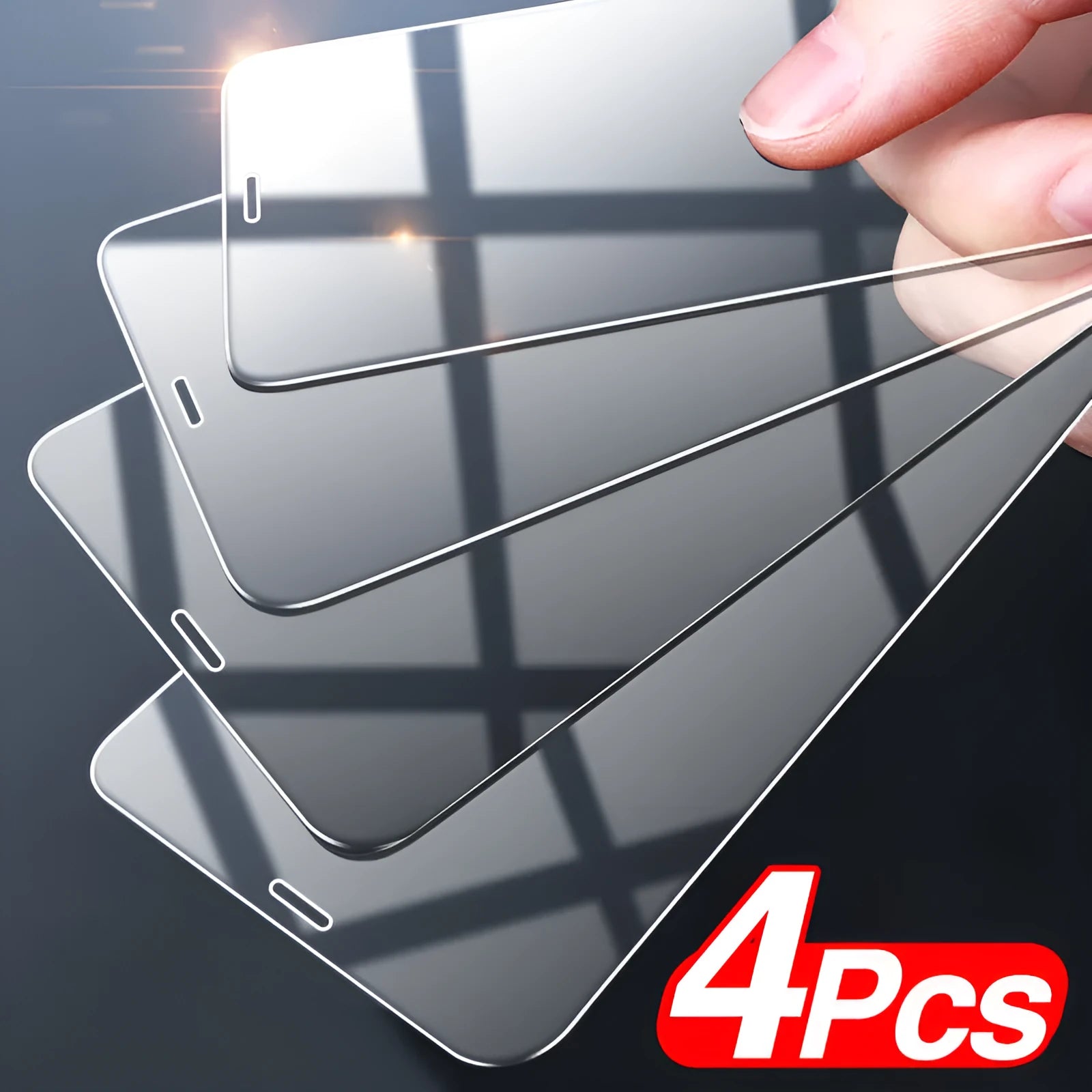 Four transparent tempered glass screen protectors for Apple iPhones on a clean surface.