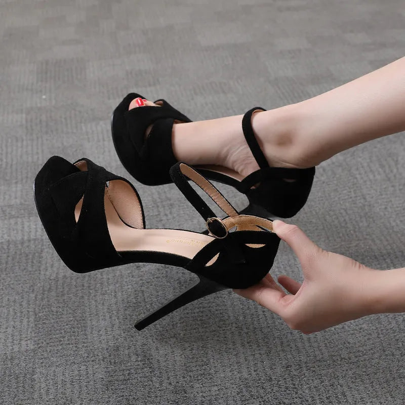 Black women's stiletto platform sandals with fish mouth toe, suede upper, and Roman style design.