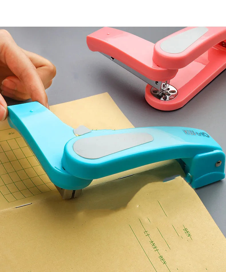 360-degree rotatable student stapler in multiple colours on a desk with paper