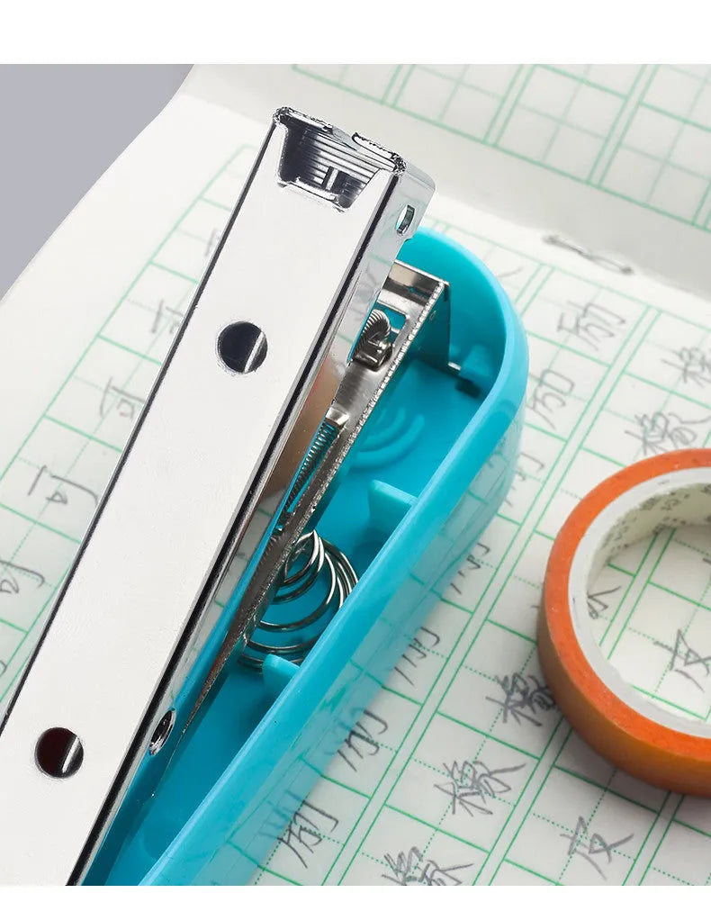 360-degree rotatable student stapler in multiple colours on a desk with paper